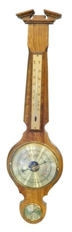 A modern three dial Weather Master barometer hygrometer, with 16cm diameter barometer in a broken arch case, 74cm high.