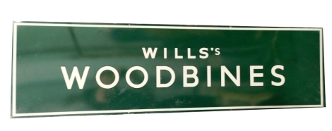 A Wills Woodbines tin advertising sign, in green and white, 43cm x 150cm.