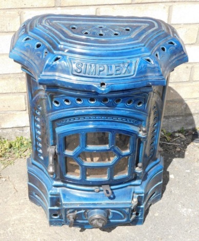 A Simplex cast iron stove, in serpentine blue casing, partially pierced with front knops, 68cm high.