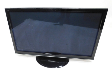 A Panasonic Viera TX-52 inch colour flat screen television, in black trim with remote controls and instructions.