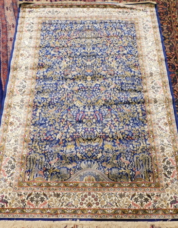 A rich blue ground Cashmere full pile Tree of Life design rug, 230cm x 160cm.