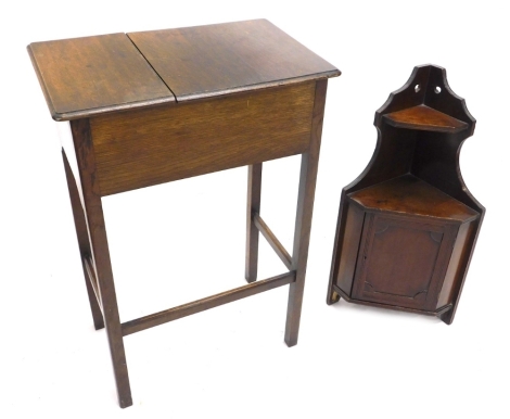 A small walnut hanging corner cabinet, with a single panelled door, 35cm wide, and an oak work table with single desk. (2)