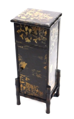 An oriental style small cabinet, with lacquered decoration picked out in gilt with buildings, figures, trees, etc., the top with a simulated bamboo border above a drawer and a single door, 59cm high, 22cm wide.