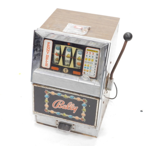 A Bally Penny Belle fruit machine or one arm bandit, with simulated rosewood sides and chrome plated mounts, 67cm high, 42cm wide. WARNING! This lot contains untested or unsafe electrical items.  It is supplied for scrap or re-conditioning only. TRADE ONL