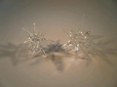 A pair of cut glass star shaped candle holders (a/f)