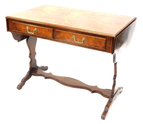 A 20thC walnut drop leaf sofa table, with elaborate house glass stretcher and scroll feet, when closed 77cm high, 105cm wide, 60cm deep.