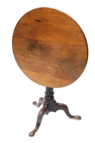 A 19thC tilt top tripod table, with circular top, gun barrel stem and triple cabriole legs, 70cm diameter.