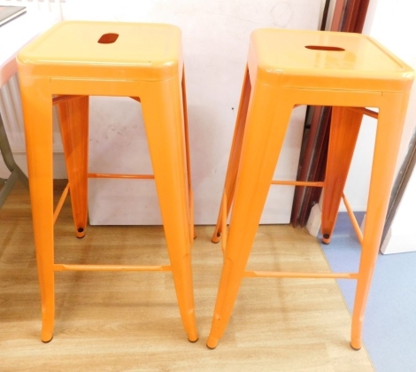 Six metal catering bar stools, with square seats, oval openings and tapering legs, joined by plain stretchers, in orange, 78cm high. (6)