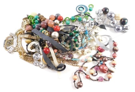 A group of modern costume jewellery, comprising chunky beaded and wooden necklaces, faux pearl necklaces, crystal style necklaces, etc. (a quantity)
