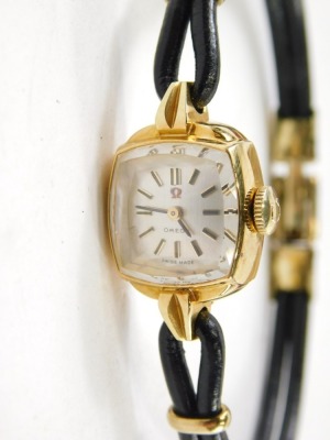 A Omega cocktail watch, with shaped square face, with 0.8cm dial, baton pointers, mother of pearl coloured face, black leather bracelet with gilt coloured mounts, in fitted case with outer box, paperwork and original receipt dated 1967 for £265. - 2