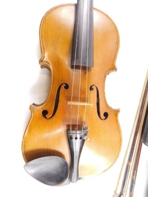 An early 20thC two piece violin, with interior hand written label, Stradivarius Anno 1714, probably German, the main body 35cm long, overall length 62cm, with three bows, in fitted case with violin scales and Arpeggios booklet and other accessories. (a qu - 3