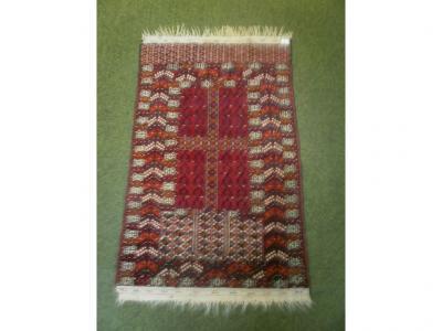 A small red ground geometric patterned rug