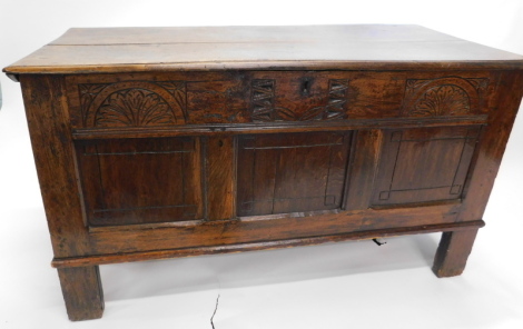 An 18thC oak coffer, of rectangular form with carved front, plain panels and block stiles, 76cm high, 134cm wide, 58cm deep.