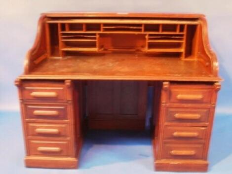 A Feige Desk Co late 19thC walnut roll top desk