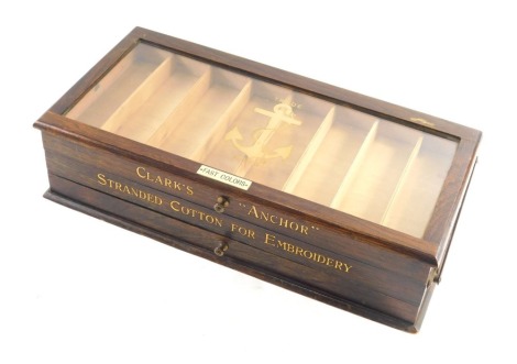 A 19thC Clark's anchor oak haberdashery cotton box, of rectangular form, with hinged glazed lid and fitted sections with removable drawer, with fitted sections and articulated body, stencilled to the front with gilt anchor trade mark, when closed 12cm hig