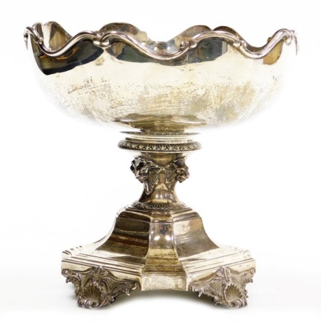 A George V silver Mappin and Webb centrepiece, with a shaped edge, the column decorated with leaves and raised lion masks, on a square tapering base, raised on four scroll cast feet, London 1920, 28.29oz, 19cm high.