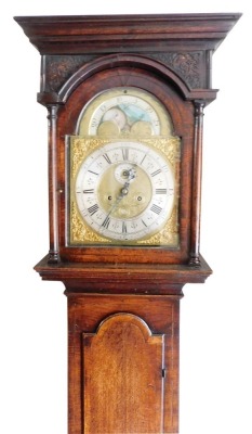 A George II oak longcase clock, by Thomas Smallwood of Sandbach, the break arch pediment with moon phase dial, brass face with silvered dial bearing Roman numerals, subsidiary seconds and date dial, eight day movement with bell strike, the square case rai