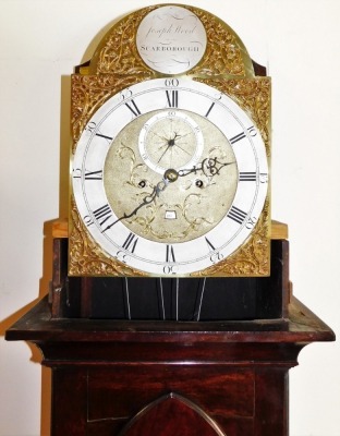 A George III mahogany longcase clock by Joseph Wood of Scarborough, the arched dial with foliate spandrels, silver chapter ring bearing Roman and Arabic numerals, subsidiary seconds dial and date aperture, eight day four pillar movement with bell strike, - 3