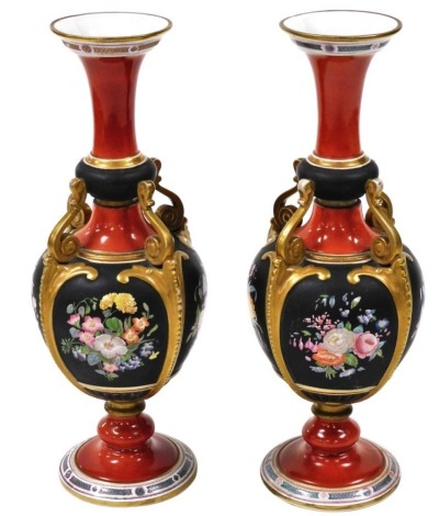 A pair of 19thC Ashworth ironstone vases, each with a tapering flared rim and bulbous body, with four scroll supports connecting body to neck, on circular base, the body decorated with floral sprays against a black ground, with red and black coloured band