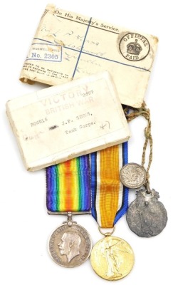 A World War I medal duo, comprising victory and campaign medals, awarded to Pte. J.P. Simms. 306516, Tank Corps, together with a tie clip and a pewter religious medallion with raised decoration.