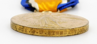 A World War I medal duo, comprising victory and campaign medals, awarded to Pte. J.P. Simms. 306516, Tank Corps, together with a tie clip and a pewter religious medallion with raised decoration. - 4