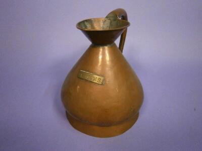 A copper one gallon measure