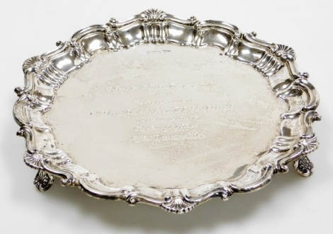 An Edward VII silver salver, with piecrust border decorated with shells, bearing presentation inscription for Hertfordshire Masters Lodge 4090 presented to W. Bro. A. S. Baker, M. M. P. A. G. D. C. As A Memento Of His Year Of Office W. M 1963-1964, raised