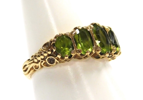 A 9ct gold and peridot five stone ring, in a graduated setting, size O, 4.4g.