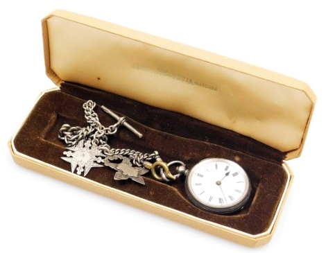 A ladies silver cased pocket watch, open face, key wind, circular enamel dial bearing Roman numerals, the case with foliate engraving, vacant shield reserve, with key, on a silver graduated curb link Albert chain, with T bar and two silver medallions fitt