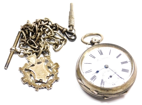 A H Samuel of Manchester gentleman's pocket watch, open face, key wind, circular enamel dial bearing Roman numerals, subsidiary seconds dial, 800 silver case, with engine turned decoration, a vacant shield and four reserve, with key, on a silver Albert ch