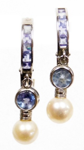 A pair of tanzanite and cultured pearl hoop and drop earrings, set in white metal, stamped 14k, 2.9g.