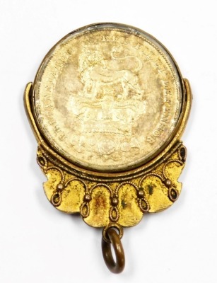 A George IV gilt shilling dated 1829, in a plated swivel pendant mount, 10.9g all in. - 2