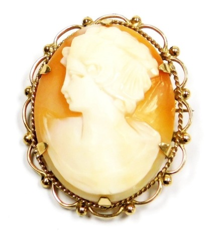 A 9ct gold and shell cameo brooch, bust portrait of a lady, with safety chain as fitted.