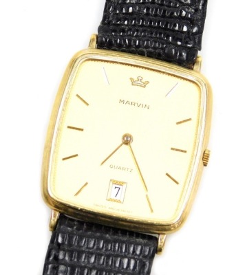 A Marvin gentleman's 9ct gold cased wristwatch, rectangular dial with engine turned decoration, date aperture, the back numbered 7090003, on a leather strap, boxed.