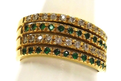 An emerald and diamond ring, pave set in a four band abstract yellow metal setting, stamped 18k, size Q, 4.9g.