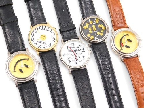 Five Joe Boxer gentleman's wristwatches, comprising a floating hands watch, floating smiley faces watch, watch with large numbers and central smiley face, and two smiley face watches on black and brown straps.