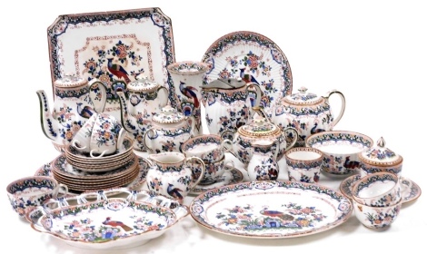 A group of late 19thC Booths pottery decorated in the Old Dutch pattern, comprising a teapot, water jug with pewter hinged lid, two sucriers, two coffee pots, a flared vase, teapot stand, bread plate, square plate, oval dish, lobed dish with pierced borde