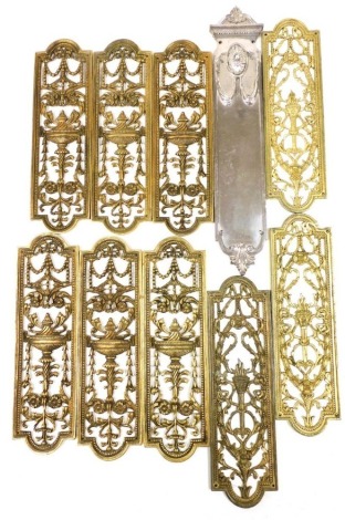 A set of six late 19thC Adam style brass door plates, embossed and pierced with vases, swags and scrolling leaves, 27cm high, three further door plates decorated with a flaming torch, chrome plated door plates, stamped WT&S. (10)