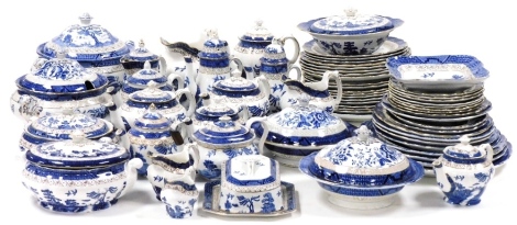 An extensive Booths pottery dinner, tea and coffee service, decorated in the Real Old Willow pattern, including graduated meat platters, soup tureen and cover, vegetable tureens and covers, dishes, plates, tea and coffee pots, butter dish and cover, cream