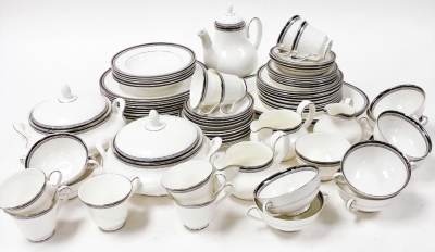 A Royal Doulton porcelain part dinner and tea coffee service, decorated in the Sarabande pattern, including meat platters, vegetable tureens and covers, coffee pot, plates and saucers, worn. (a quantity)