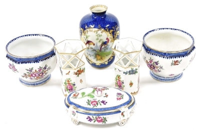 A group of Booths pottery, comprising a pair of hexagonal vases with pierced tops, decorated with panels of flowers, for Gilman Collamore New York, 12.5cm high, an oval dressing table box and cover decorated with floral sprays, for Liberty & Company Limit