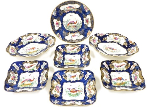 A group of Booths Blue Scale pattern dessert wares, decorated with reserves of exotic birds and flowers, comprising a pair of oval dishes for Gilman Collamore New York, four square dishes for T Goode & Company London, and a circular plate. (7)