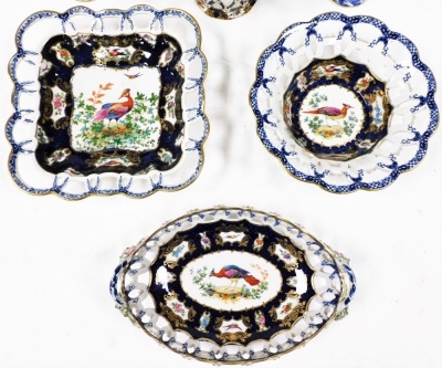 Six items of late 19thC Booths Blue Scale pattern basket weave pottery, decorated with reserves of exotic birds and flowers, comprising a pair of flared vases, 13cm high, oval, square and round baskets, and a twin handle basket. (6) - 2