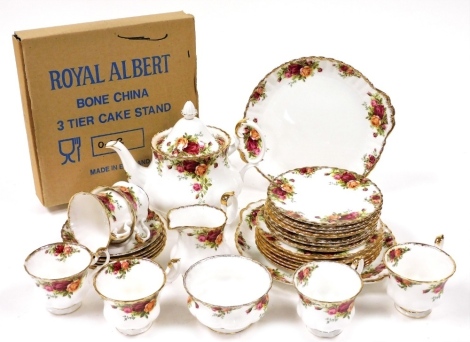 A Royal Albert porcelain part tea service, decorated in The Old Country Roses pattern, comprising teapot, cream jug, sugar bowl, pair of bread plates, three tier cake stand, six teacups and saucers, and fifteen tea plates.