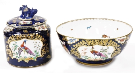 A late 19thC Booths Blue Scale pattern jar and cover, of cylindrical form, the cover with a dog of fo finial, decorated with reserves of exotic birds and flowers, for Maple of London, 19cm wide, together with a Blue Scale pattern fruit bowl, 30cm wide. (2