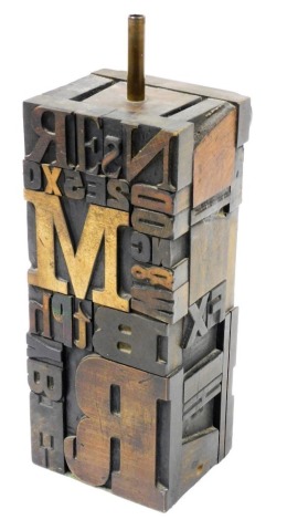 A contemporary wooden double cube form table lamp, of type setting letter decorative form, 36cm high.