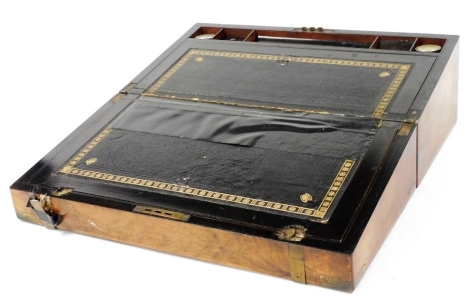 A Victorian walnut and brass bound writing slope, of rectangular section, opening to reveal a gilt tooled leather slope and fitted interior, 50cm wide, 26cm deep.