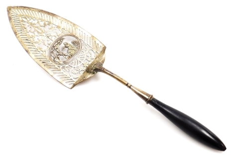 A Continental white metal serving slice, with cast and pierced decoration, and an ebonised handle, possibly German, stamped G M 13.