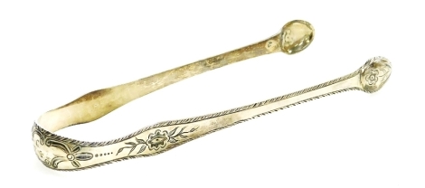 A pair of Georgian silver sugar tongs, decorated with flowers and monogrammed cartouche, hallmarks rubbed, 1.01oz, 14cm long.