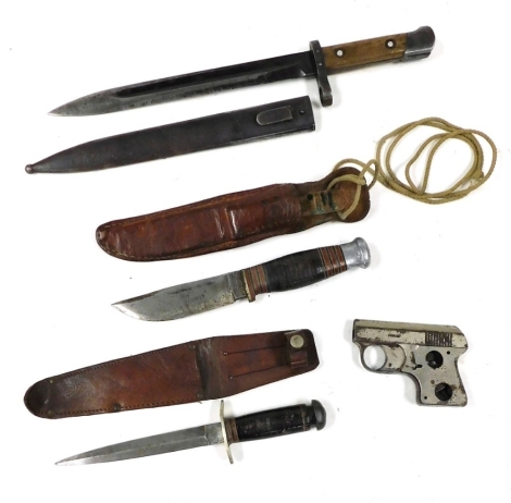 An early 20thC boy Scout knife, the leather scabbard indistinctly engraved, a Bowie knife stamped William Rogers, Sheffield, a short bayonet and a pistol cigarette lighter. (AF) (4)